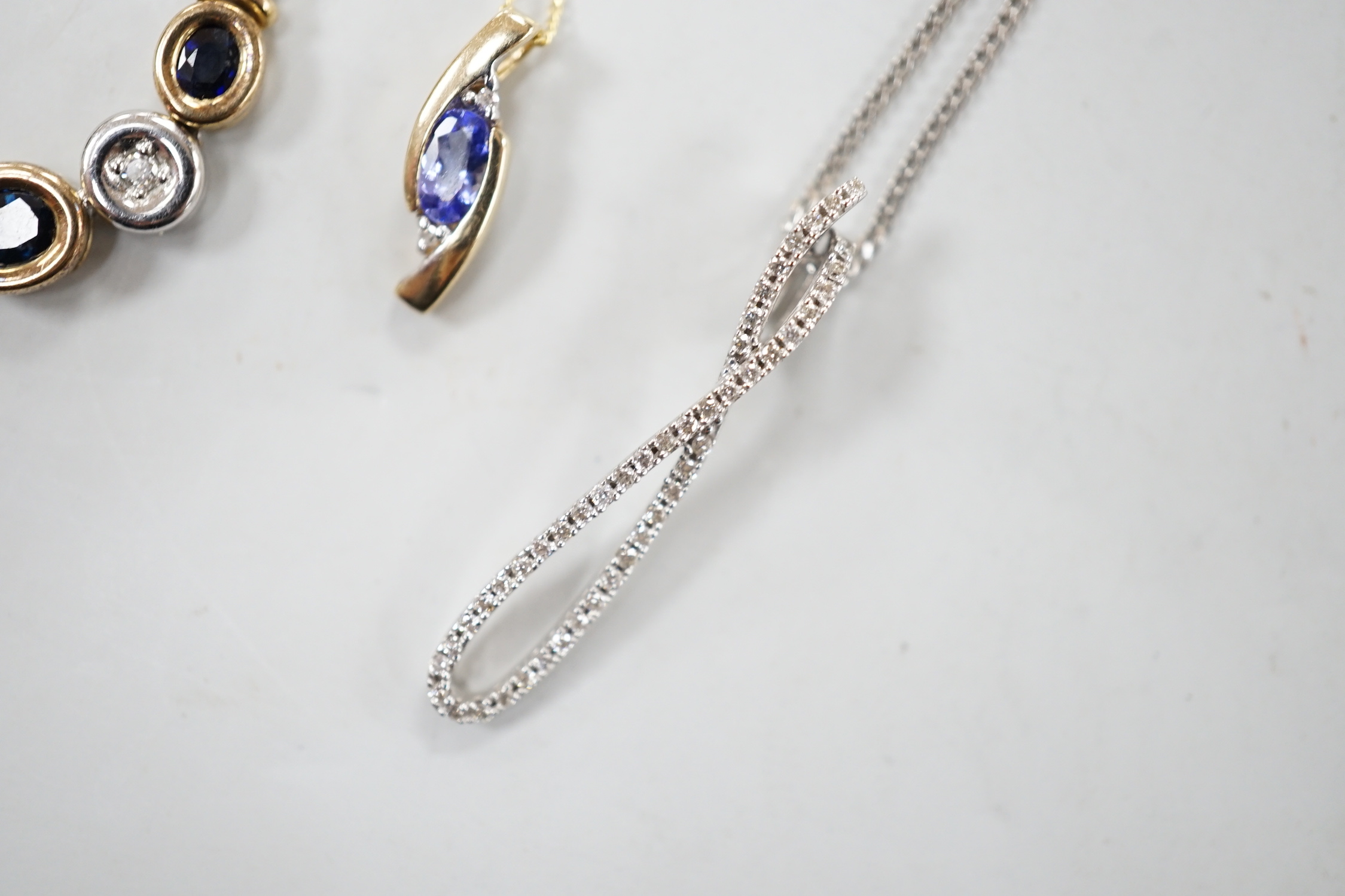 Four assorted modern 375 and gem set pendant necklaces, including white 375 and diamond chip set, 50cm and white 375 and emerald drop set, gross weight 11.3 grams.